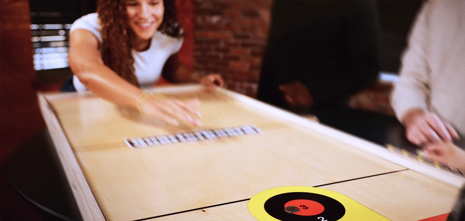 young woman making a shot on a QuarterBoard game